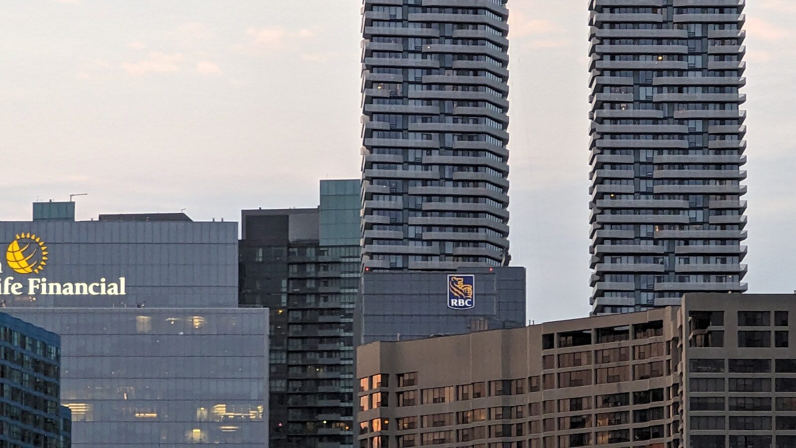 a couple of tall buildings sitting next to each other