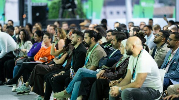Diverse audience attentively listening at a conference event.